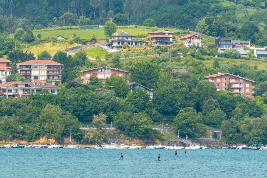 A group of friends doing paddle surfing in the sea in Urdaibai, a Bizkaia