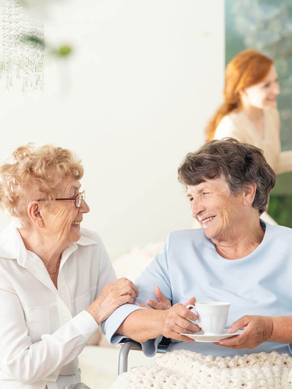 front-view-of-two-happy-geriatric-women-talking-KBTSGJ9.jpg